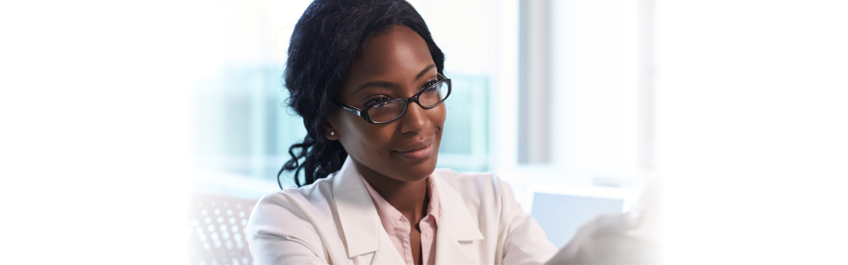 Doctor In White Coat Examining Female Patient In Office